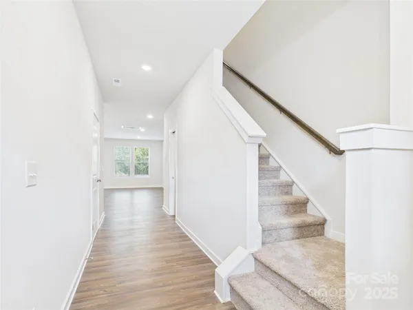 a view of entryway and hall with wooden floor