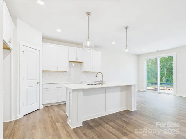 a view of a kitchen with a sink cabinets and wooden floor