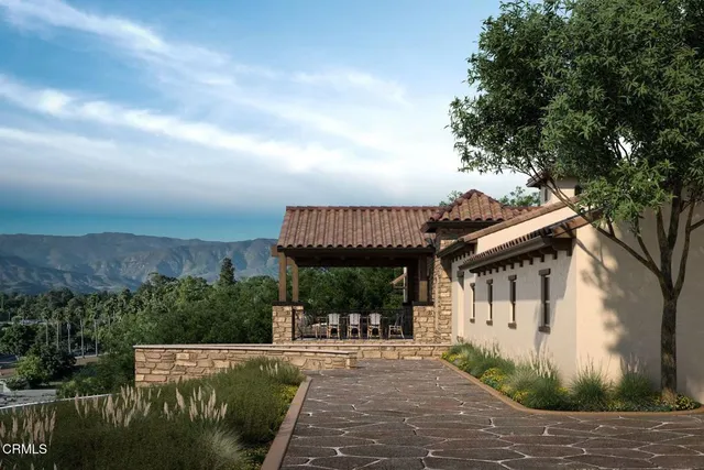 a view of a house with backyard and sitting area