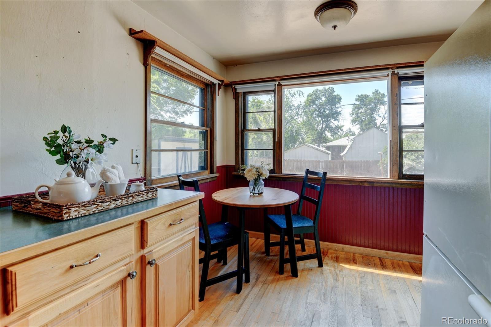 6788 Pierce Way Arvada, CO 80003 - Photo 14 of 28 a dining room with furniture and window