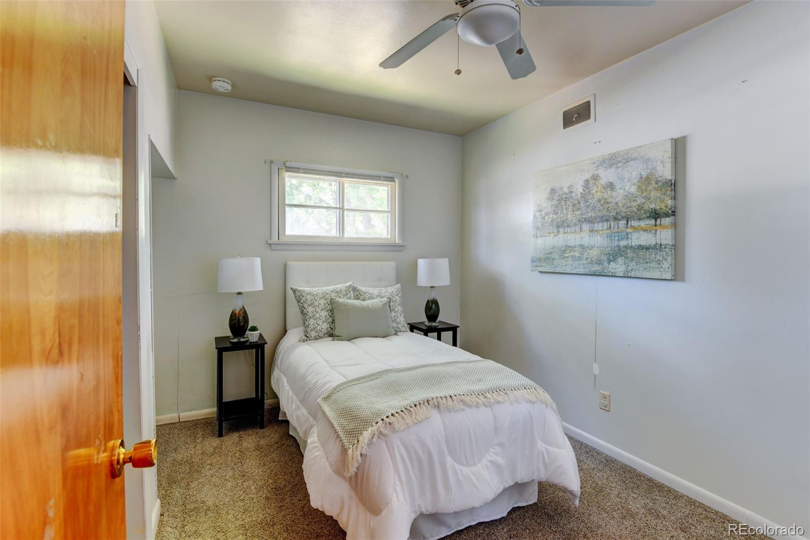 6788 Pierce Way Arvada, CO 80003 - Photo 18 of 28 a bedroom with a bed and a window