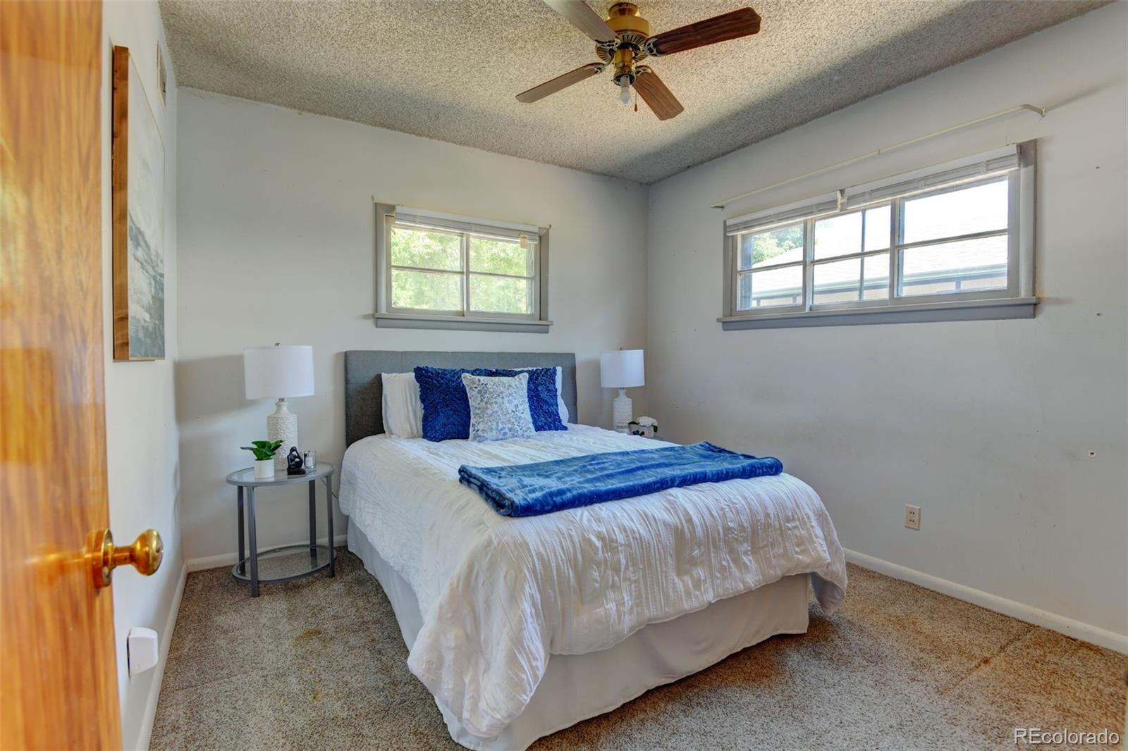 6788 Pierce Way Arvada, CO 80003 - Photo 19 of 28 a bedroom with a bed and window