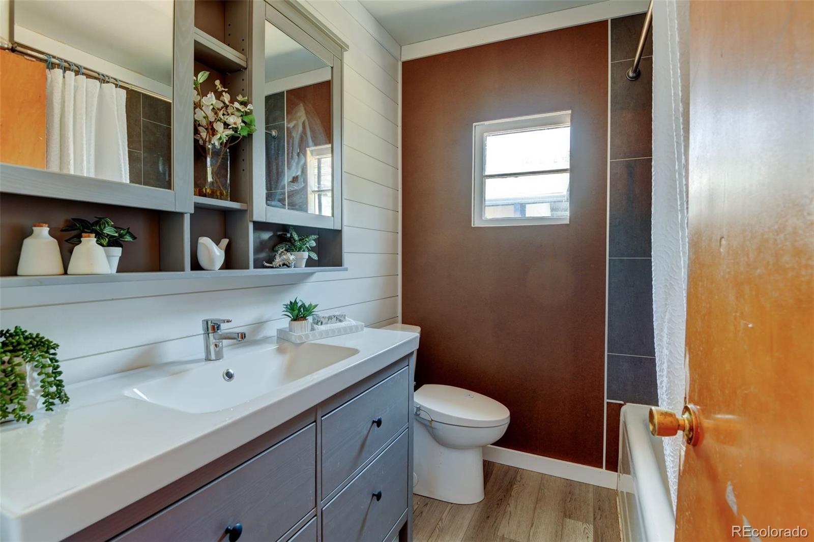 6788 Pierce Way Arvada, CO 80003 - Photo 20 of 28 a bathroom with a sink a toilet and shower