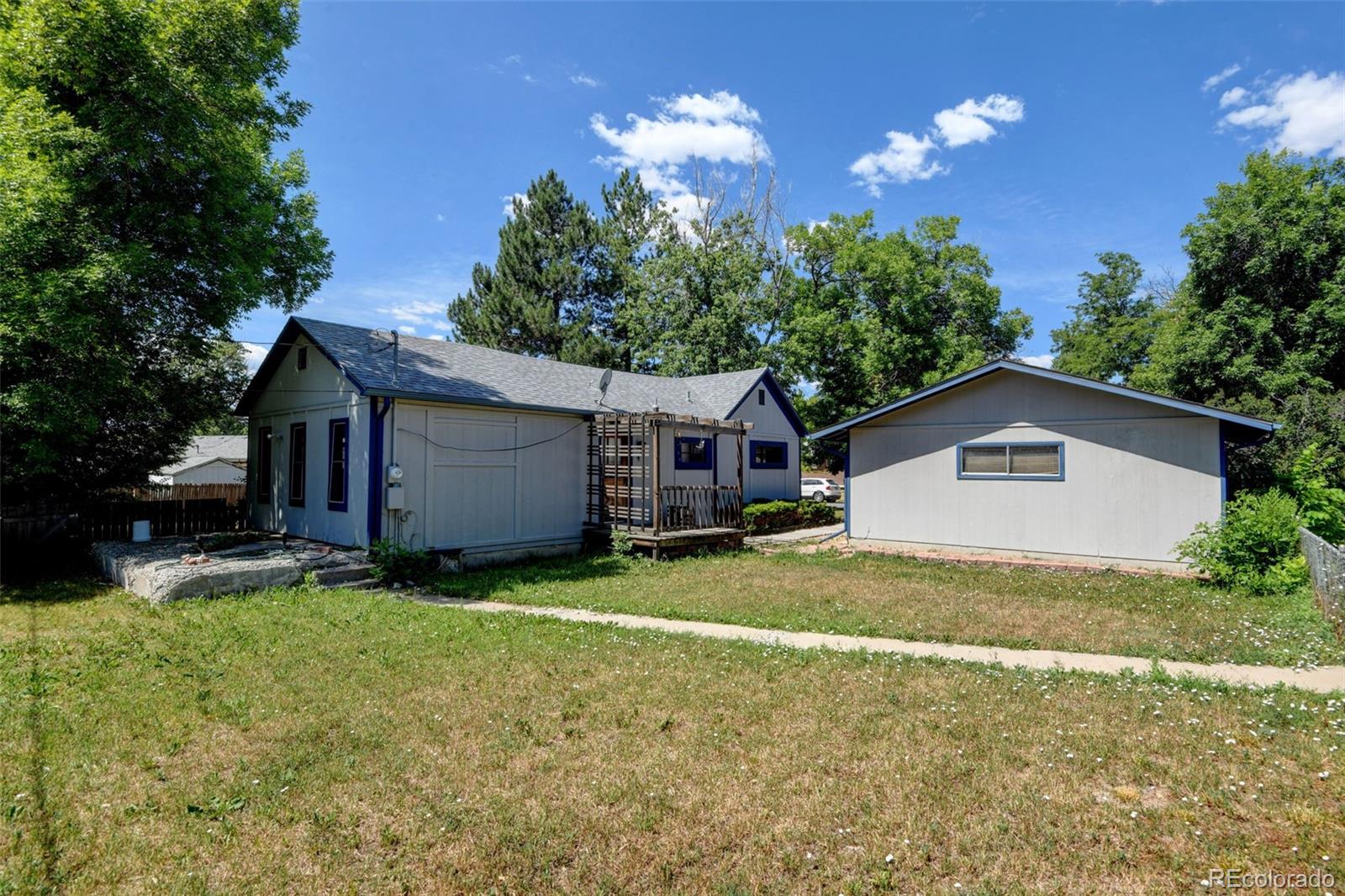 6788 Pierce Way Arvada, CO 80003 - Photo 26 of 28 a view of a house with a yard and large tree