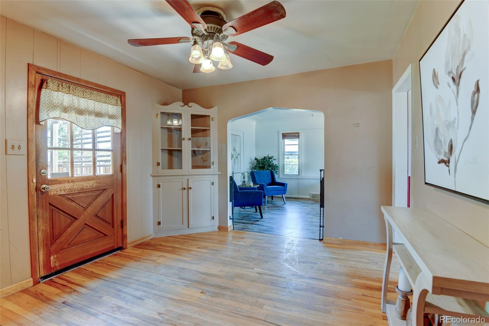 6788 Pierce Way Arvada, CO 80003 - Photo 7 of 28 a living room with furniture and a chandelier