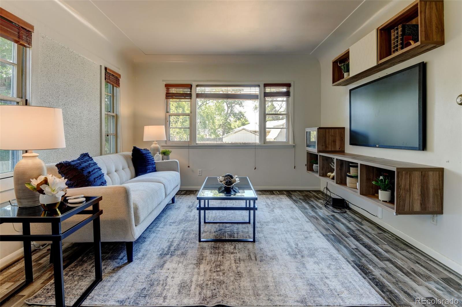 6788 Pierce Way Arvada, CO 80003 - Photo 9 of 28 a living room with furniture and a flat screen tv
