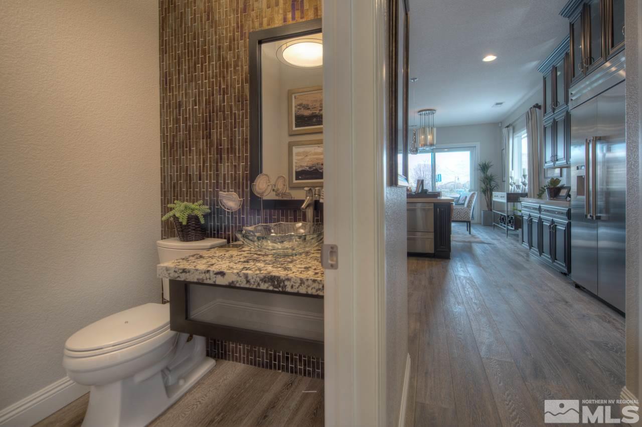 2095 Altair Lane, Unit MESSINA MODEL LOT 32 Reno, NV 89521 - Photo 13 of 25 a bathroom with a granite countertop sink a toilet a mirror and shower