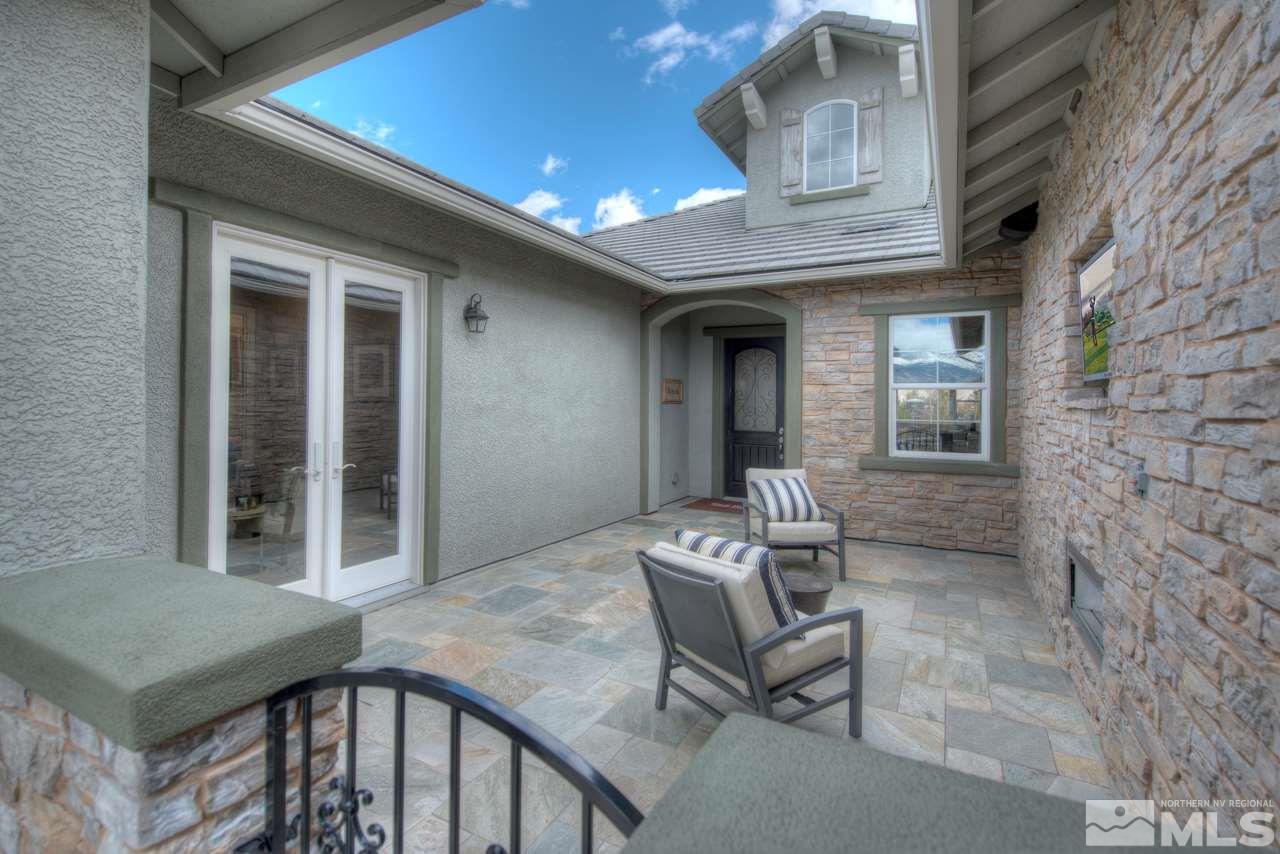 2095 Altair Lane, Unit MESSINA MODEL LOT 32 Reno, NV 89521 - Photo 2 of 25 a balcony with table and chairs