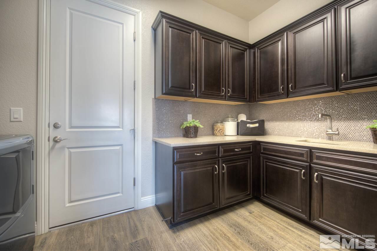 2095 Altair Lane, Unit MESSINA MODEL LOT 32 Reno, NV 89521 - Photo 23 of 25 a kitchen with stainless steel appliances granite countertop cabinets and wooden floor