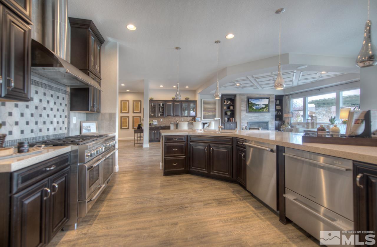 2095 Altair Lane, Unit MESSINA MODEL LOT 32 Reno, NV 89521 - Photo 7 of 25 a large kitchen with stainless steel appliances granite countertop plenty wooden cabinets counter space a sink and a stove