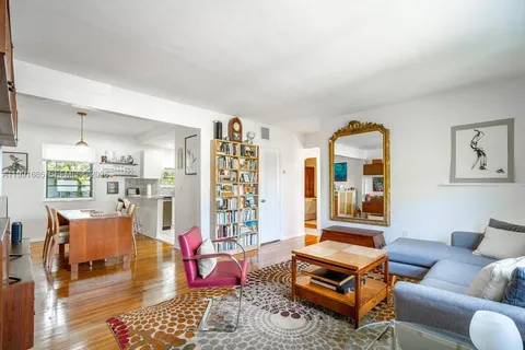 a living room with furniture a rug and a large window