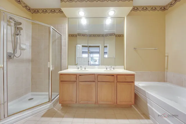 a bathroom with a tub sink shower and mirror