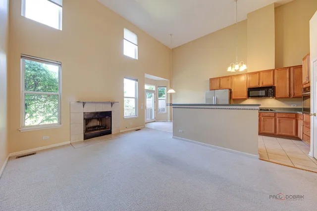 a view of a kitchen with a sink cabinets and a fireplace