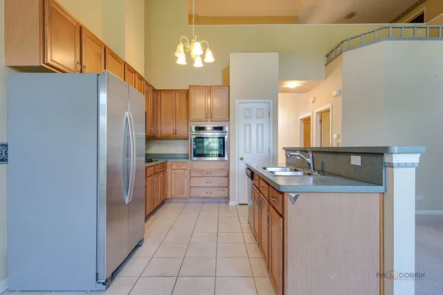 a kitchen with stainless steel appliances granite countertop a sink and cabinets