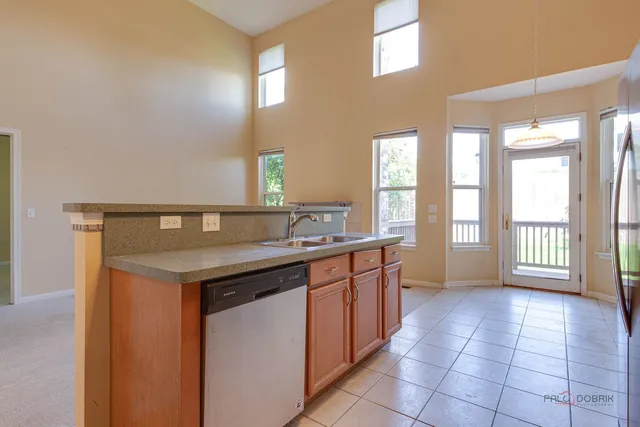 a view of a kitchen with a sink and a window