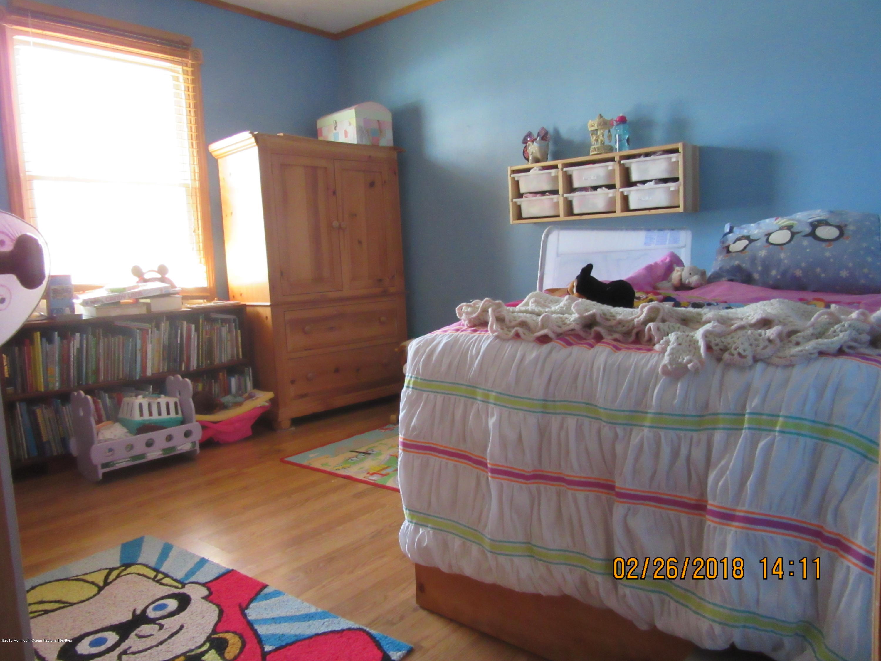 174 Raritan Street Keyport, NJ 07735 - Photo 1 of 23 a bedroom with a bed and wooden floor