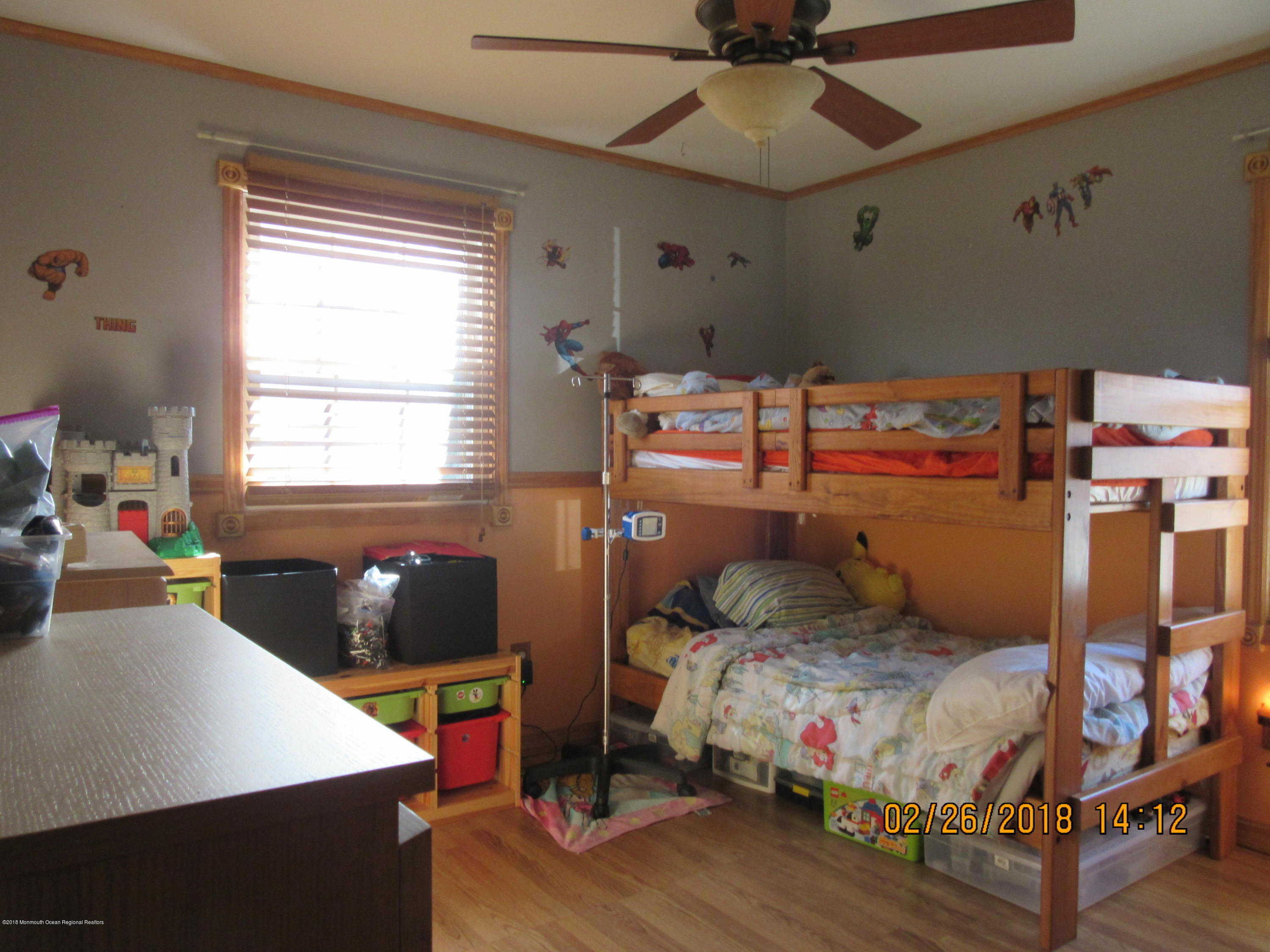 174 Raritan Street Keyport, NJ 07735 - Photo 2 of 23 a bedroom with a bed and a chandelier