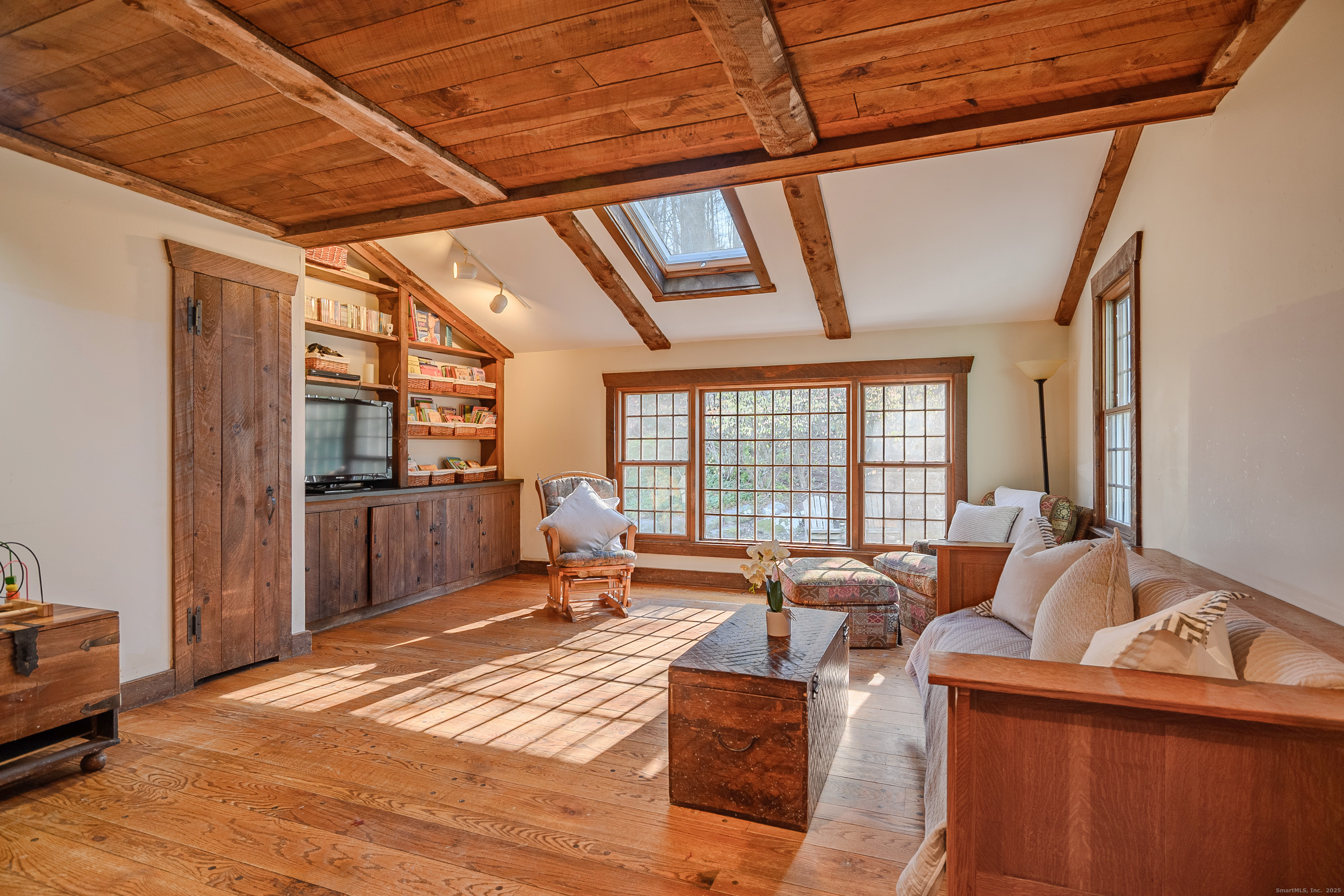 14 Concord Ridge Road Newtown, CT 06482 - Photo 13 of 40 a living room with furniture a flat screen tv and floor to ceiling window