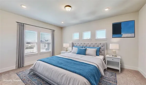a bedroom with a large bed and a window