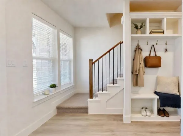 a view of entryway and hall with wooden floor