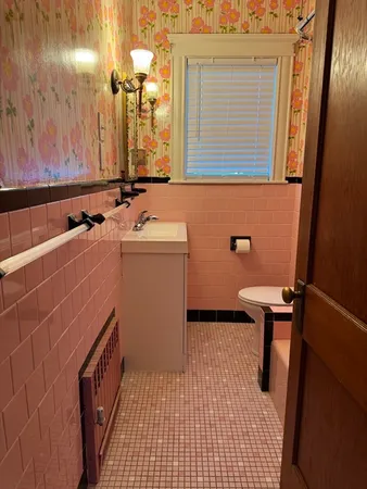 a bathroom with a sink a toilet and a mirror