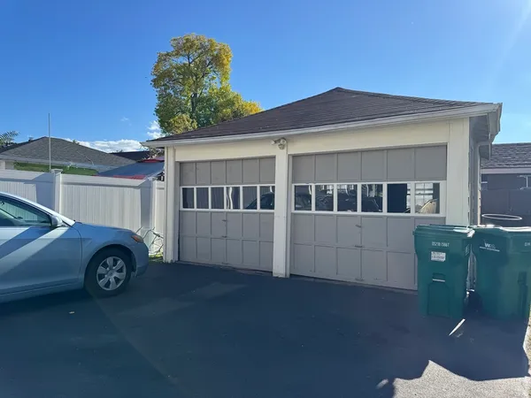 a front view of a house with plants
