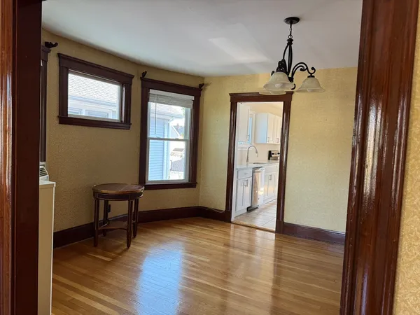 a view of a room with wooden floor and windows