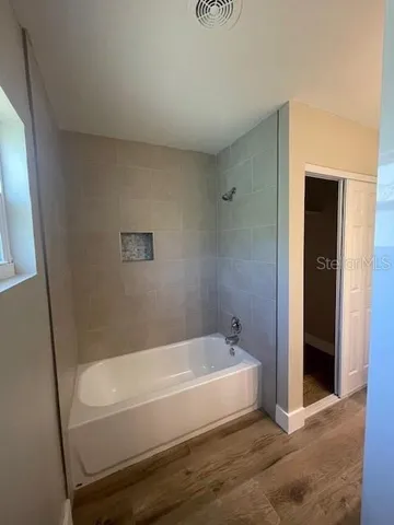 a bathroom with a bathtub and shower