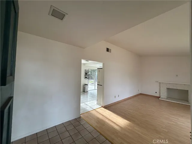 an empty room with closet and windows