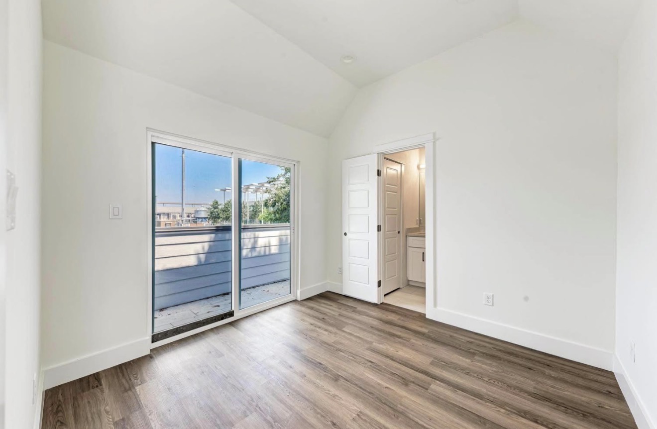 502 Tillery Street, Unit 2 Austin, TX 78702 - Photo 9 of 15 an empty room with wooden floor and sliding door