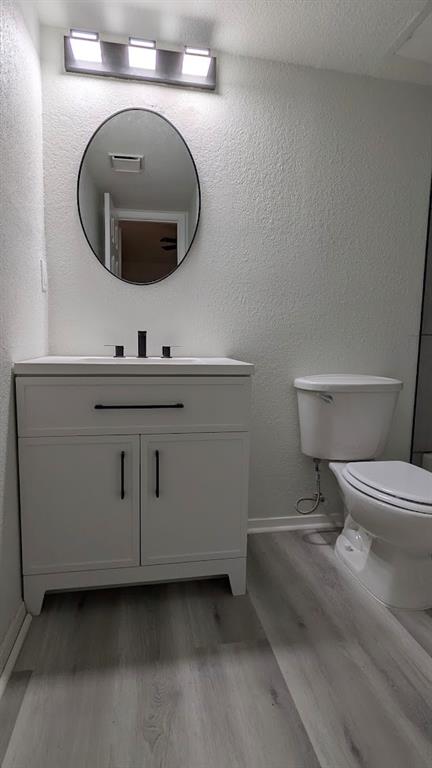 2240 Tarpley Road, Unit 92 Carrollton, TX 75006 - Photo 13 of 17 a bathroom with a toilet a sink and mirror