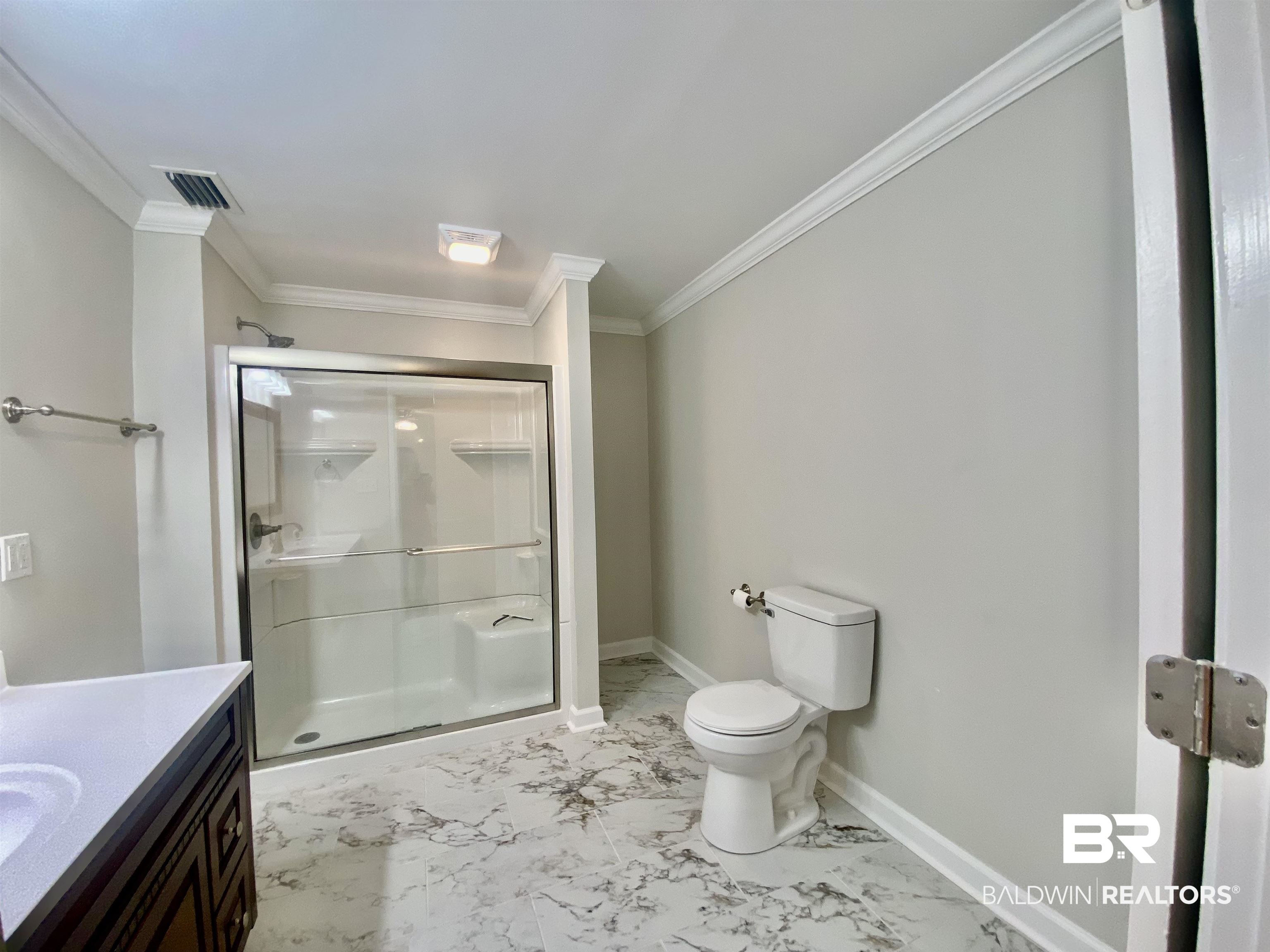 265 Azalea Drive Monroeville, AL 36460 - Photo 28 of 39 Bathroom with toilet, vanity, an enclosed shower, and crown molding