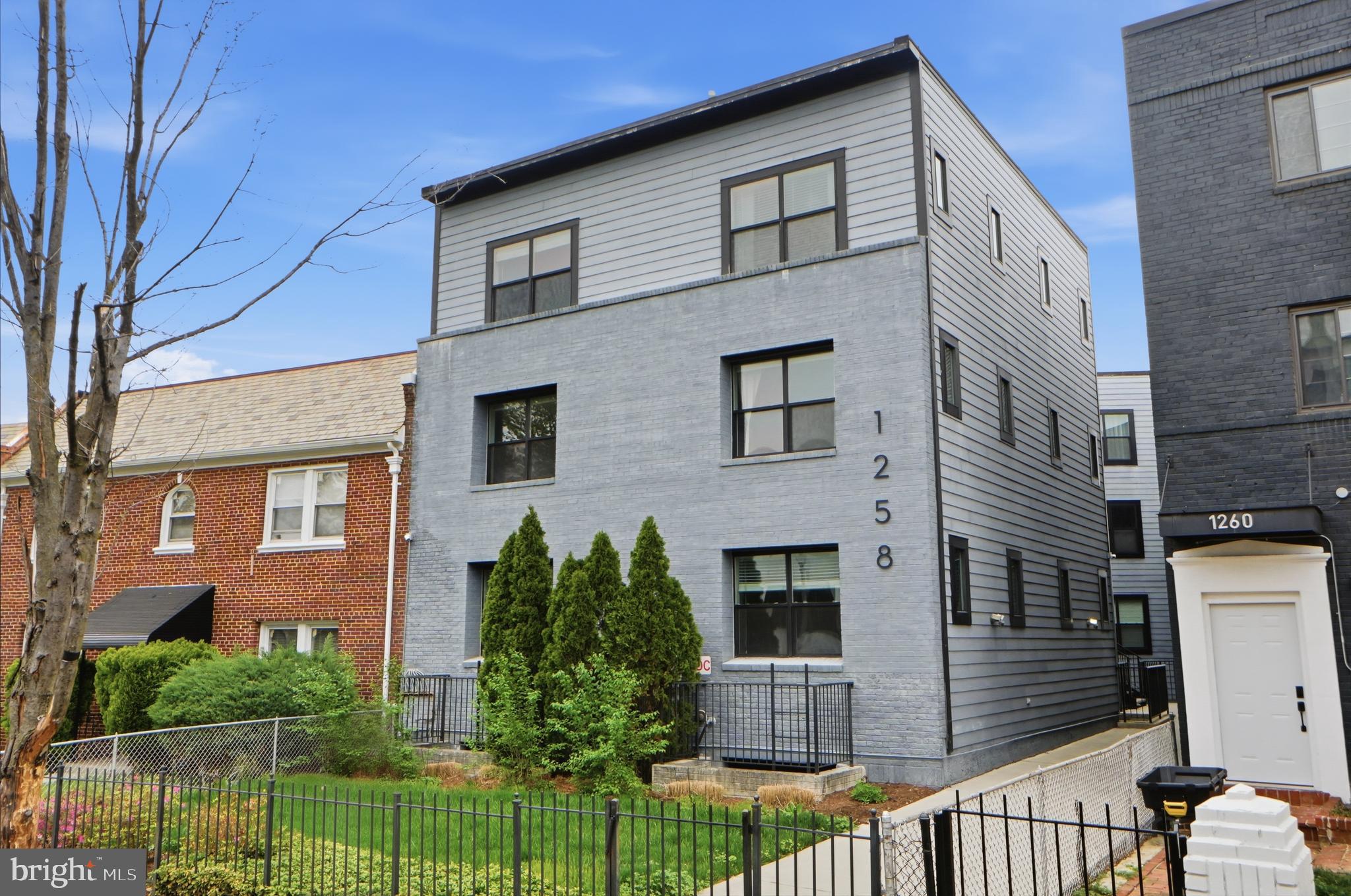 1258 Holbrook Terrace Northeast, Unit 5 Washington, DC 20002 - Photo 1 of 25 a front view of a house with a yard