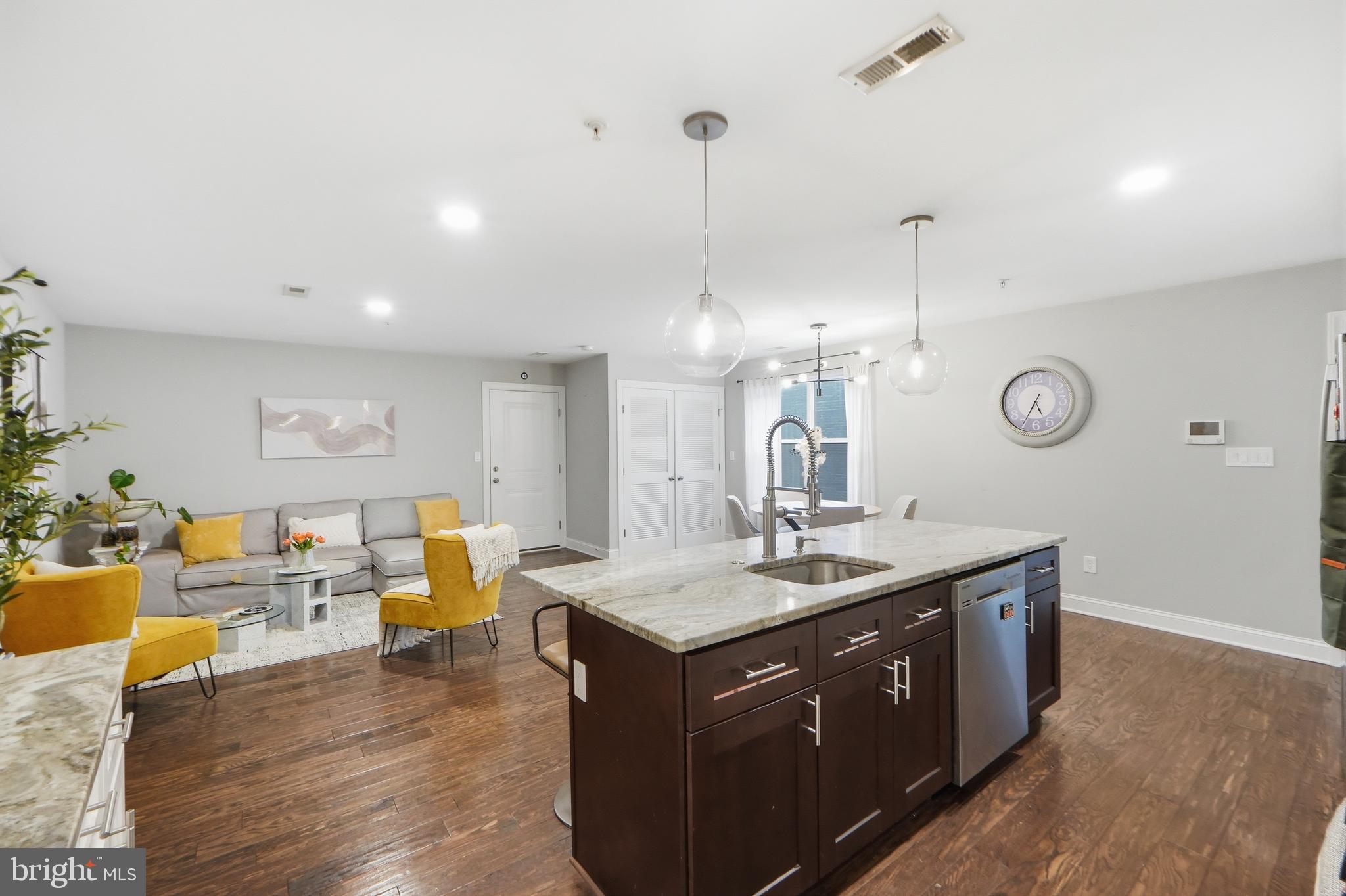 1258 Holbrook Terrace Northeast, Unit 5 Washington, DC 20002 - Photo 13 of 25 a living room with stainless steel appliances granite countertop couches a fireplace with wooden floor