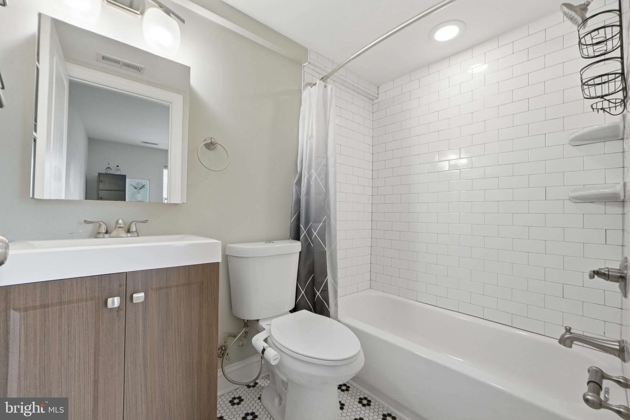 1258 Holbrook Terrace Northeast, Unit 5 Washington, DC 20002 - Photo 18 of 25 a bathroom with a sink toilet and shower