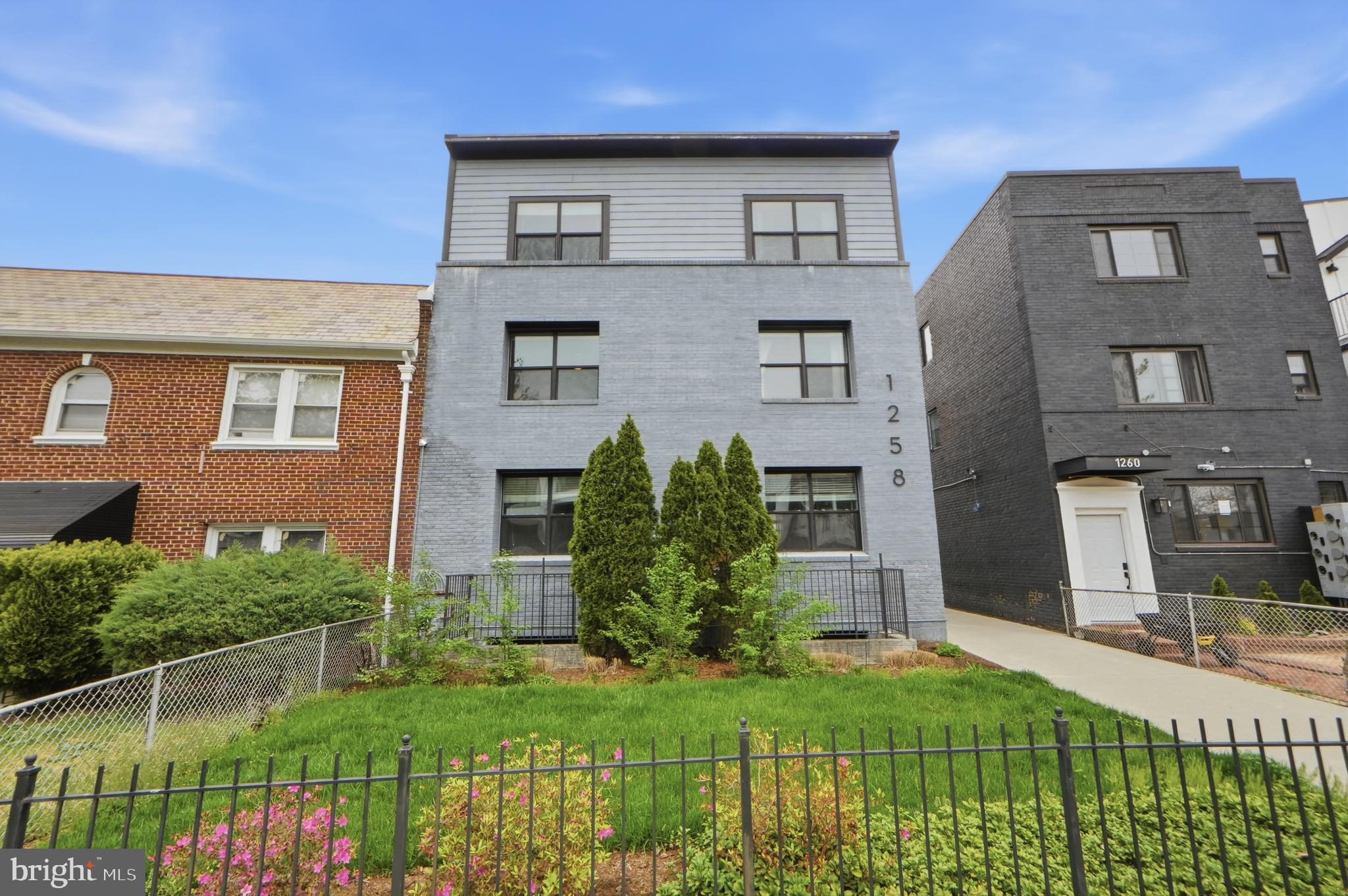 1258 Holbrook Terrace Northeast, Unit 5 Washington, DC 20002 - Photo 2 of 25 a front view of a house with a yard