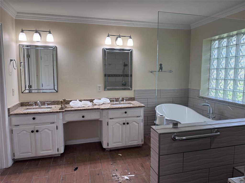 1704 South Bowen Road Pantego, TX 76013 - Photo 15 of 37 Bathroom featuring a dual vanity with granite countertops, undermount sinks, white cabinetry, and brushed nickel hardware