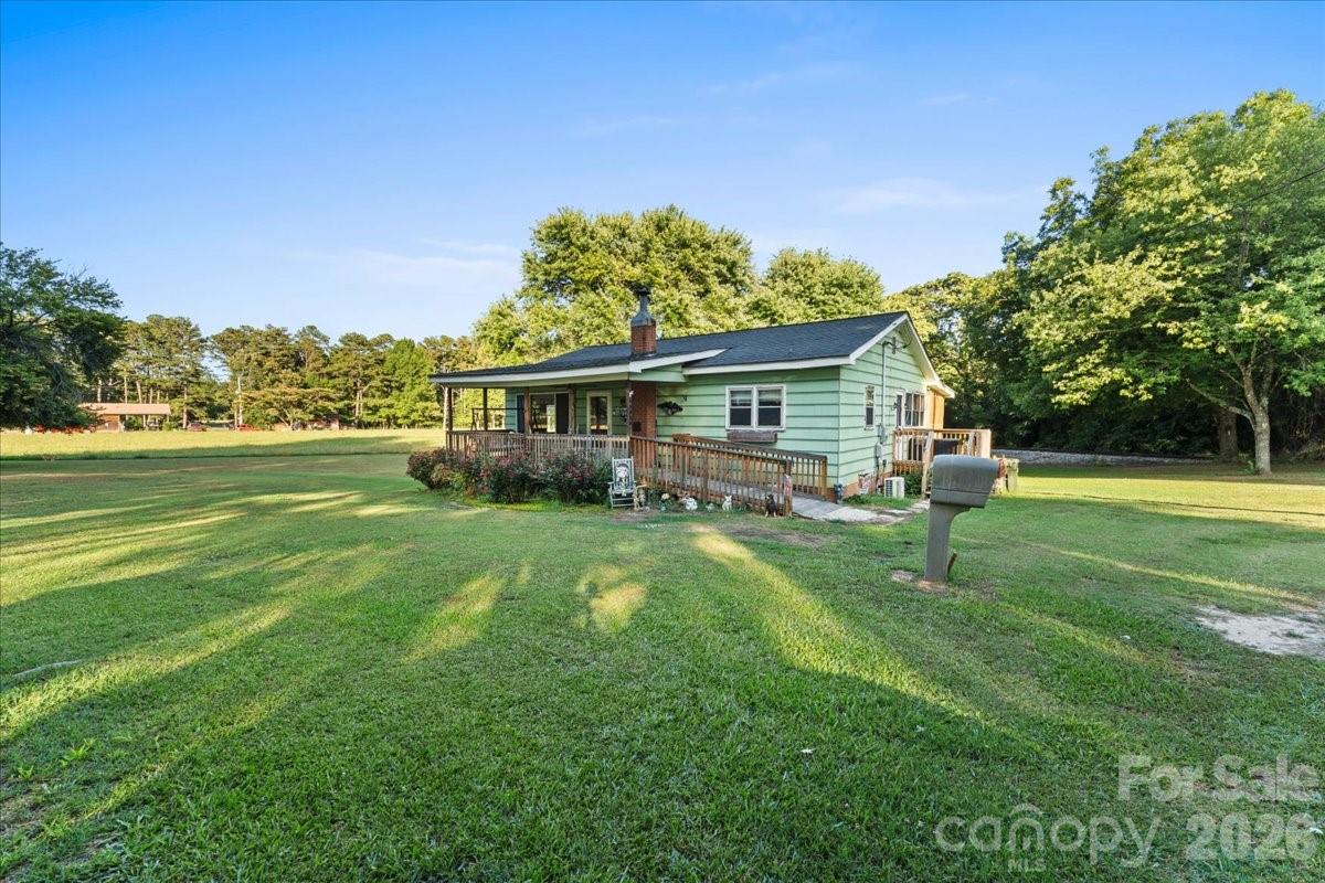 12282 Coyle Road Stanfield, NC 28163 - Photo 17 of 24 a view of a house with a big yard
