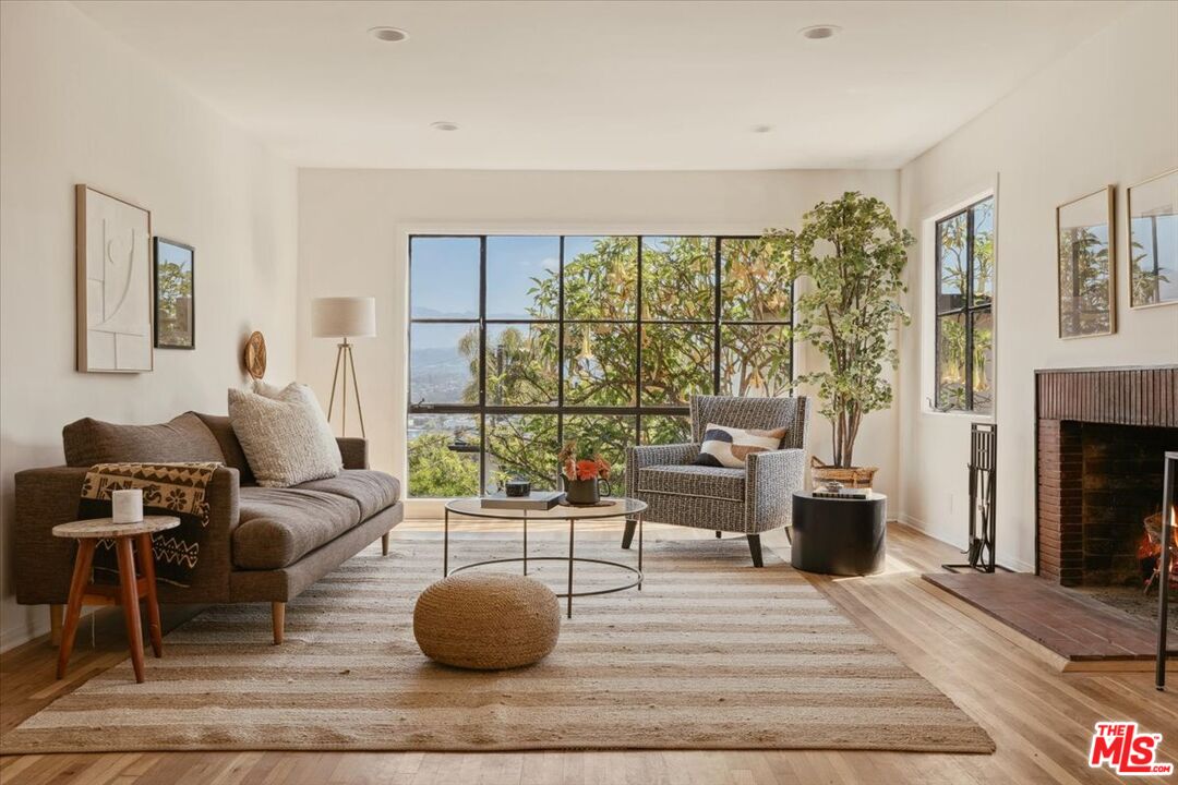 2467 Silver Ridge Avenue Los Angeles, CA 90039 - Photo 1 of 42 a living room with furniture and a fireplace