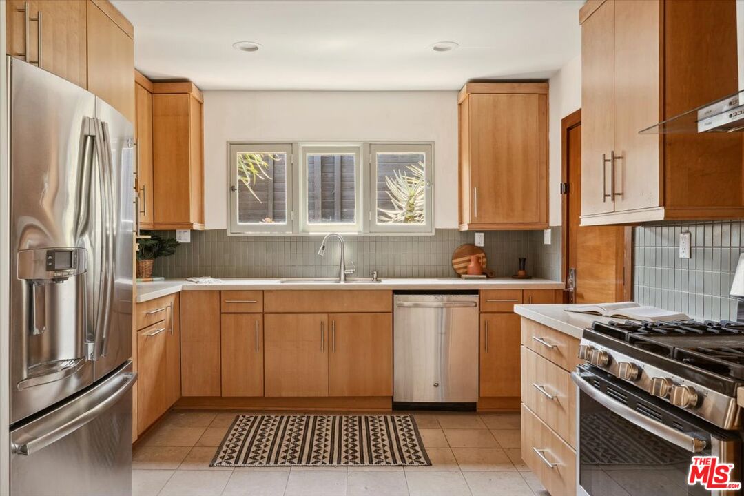 2467 Silver Ridge Avenue Los Angeles, CA 90039 - Photo 13 of 42 a kitchen with stainless steel appliances granite countertop a stove a sink and a refrigerator