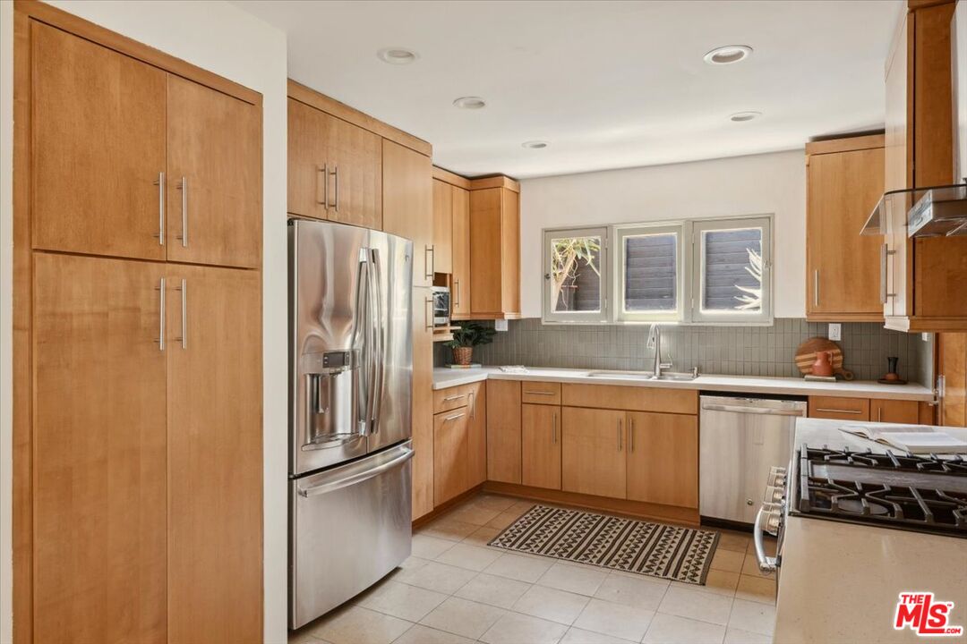 2467 Silver Ridge Avenue Los Angeles, CA 90039 - Photo 14 of 42 a kitchen with stainless steel appliances granite countertop a refrigerator and a sink