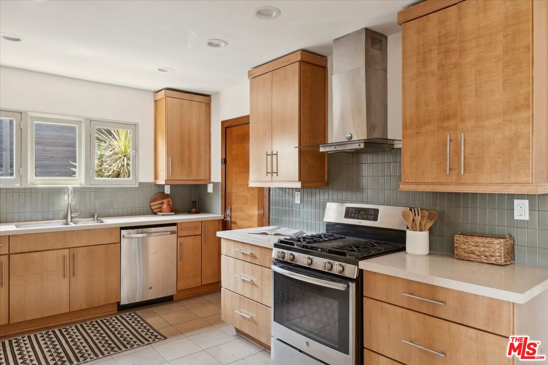 2467 Silver Ridge Avenue Los Angeles, CA 90039 - Photo 15 of 42 a kitchen with stainless steel appliances a sink stove and cabinets