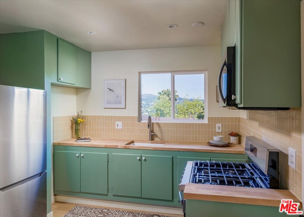 2467 Silver Ridge Avenue Los Angeles, CA 90039 - Photo 24 of 42 a kitchen with sink a window and refrigerator