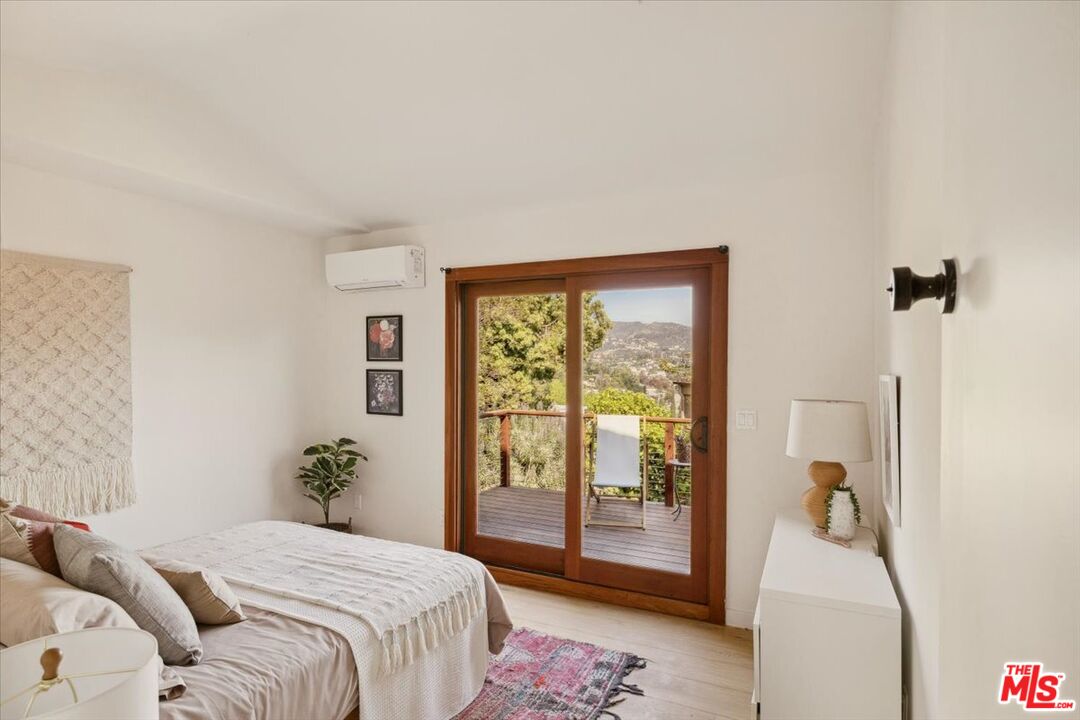 2467 Silver Ridge Avenue Los Angeles, CA 90039 - Photo 31 of 42 a bedroom with a balcony a bed and a couch