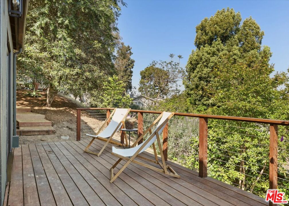 2467 Silver Ridge Avenue Los Angeles, CA 90039 - Photo 35 of 42 a view of a balcony with wooden floor and iron fence
