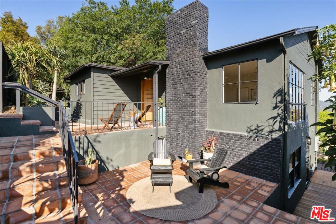 2467 Silver Ridge Avenue Los Angeles, CA 90039 - Photo 4 of 42 a view of a patio with table and chairs with wooden floor and fence