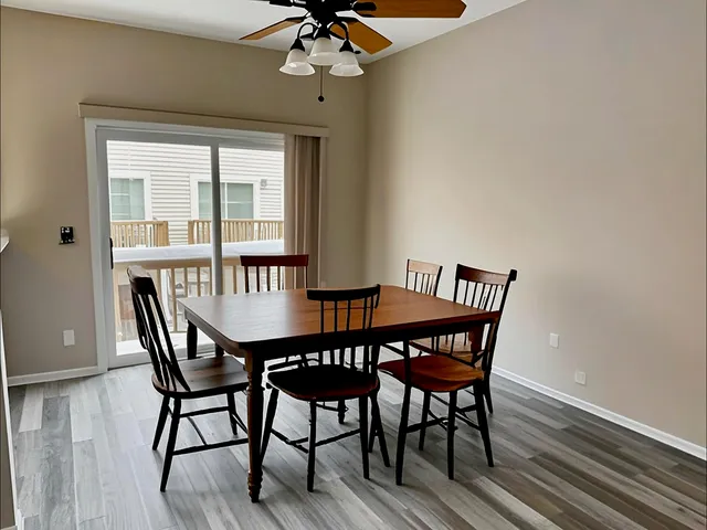 a view of a dining room with furniture wooden floor and chandelier