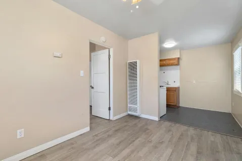 a view of empty room with wooden floor