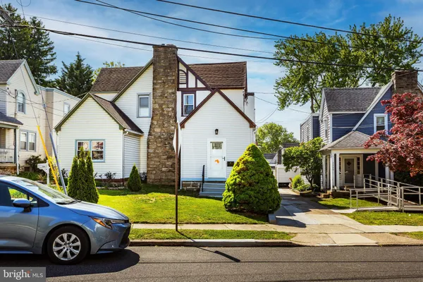 a view of a car parked in front of a house