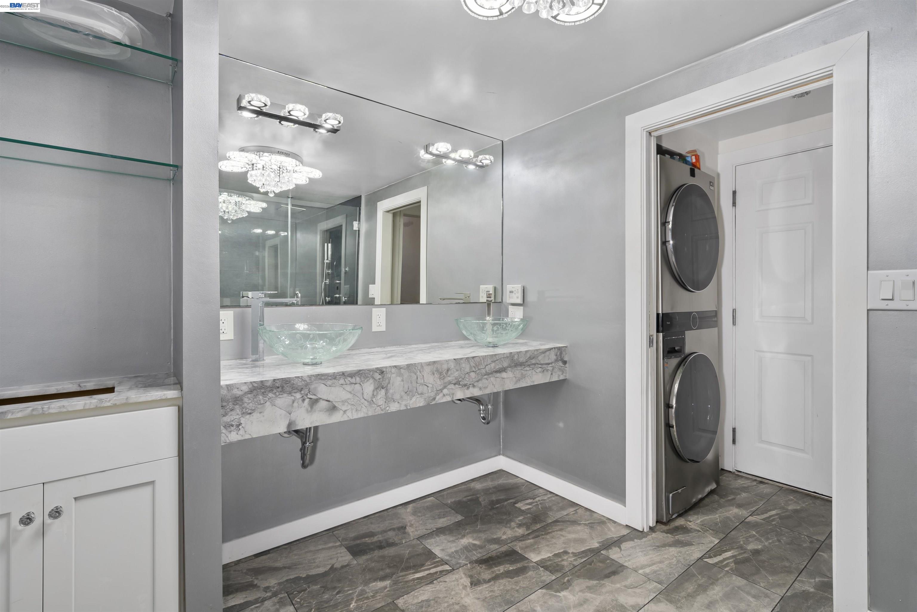 24849 2nd Street Hayward, CA 94541 - Photo 11 of 24 a bathroom with a granite countertop sink and a mirror